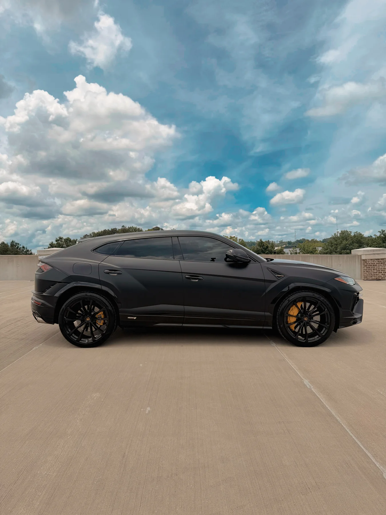 Matte black Lamborghini Urus S side profile